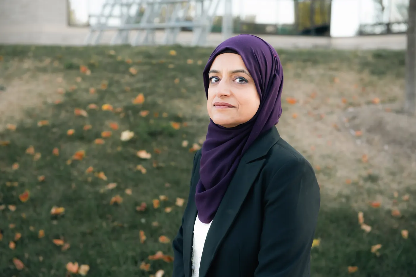 Najia Mahmud, family lawyer, standing in a park in autumn